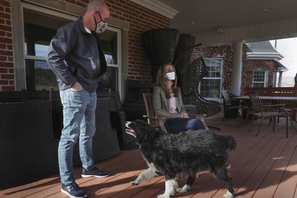 Spencer Cox stands with his wife and dog on their porch in Sanpete County wher<em></em>e they discuss his recent win as Utah governor.&nbsp;