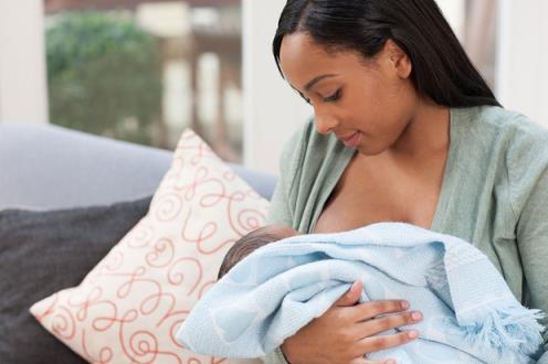 woman breastfeeding newborn