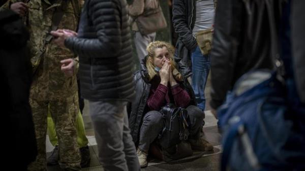 A woman waits for a train trying to leave Kyiv, Ukraine. (Photo: AP)