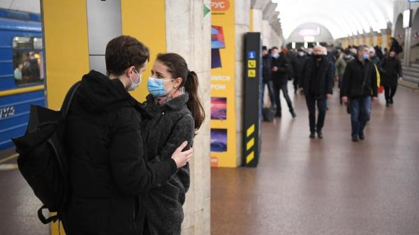 A couple at a metro station.