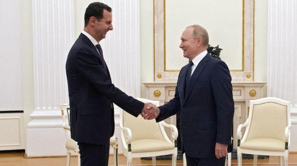 Russian President Vladimir Putin shakes hands with Syrian President Bashar al-Assad during a meeting at the Kremlin in Moscow, Russia
