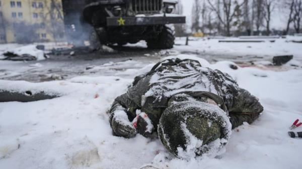 Russia-Ukraine war updates: The body of a serviceman is coated in snow next to a destroyed Russian military multiple rocket launcher vehicle on the outskirts of Kharkiv, Ukraine. (Image: AP)