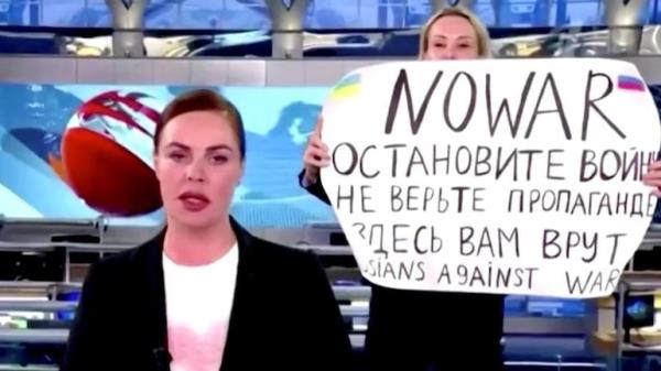 A Russian woman was detained after she interrupted a live news broadcast with an anti-war sign. (Photo: Screengrab)