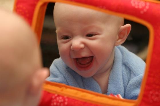 baby laughing at mirror