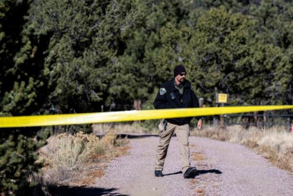 A member of the Custer County Sheriff's Office works the scene of a shooting on Tuesday, Nov. 21, 2023 near Westcliffe, Colo. (Parker Seibold/The Gazette via AP)